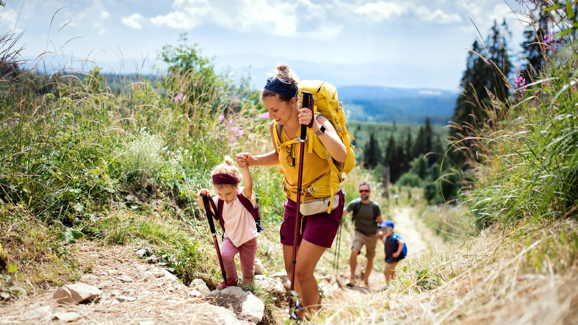 family hiking on a steep mountain hill