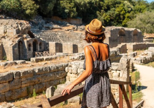 A woman visiting the archaeological ruins of the Butrint or Butrinto National Park in Albania